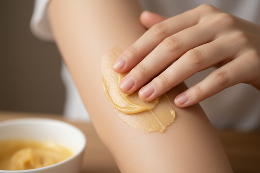 A person applying unrefined shea butter to their arm to soothe eczema and calm itchy skin naturally.
