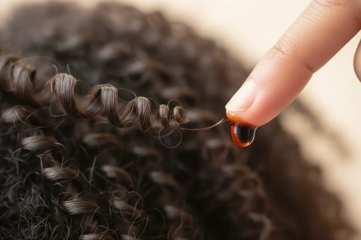 A close-up of a healthy, sealed hair end, showing how Batana oil is used as a natural split end treatment.