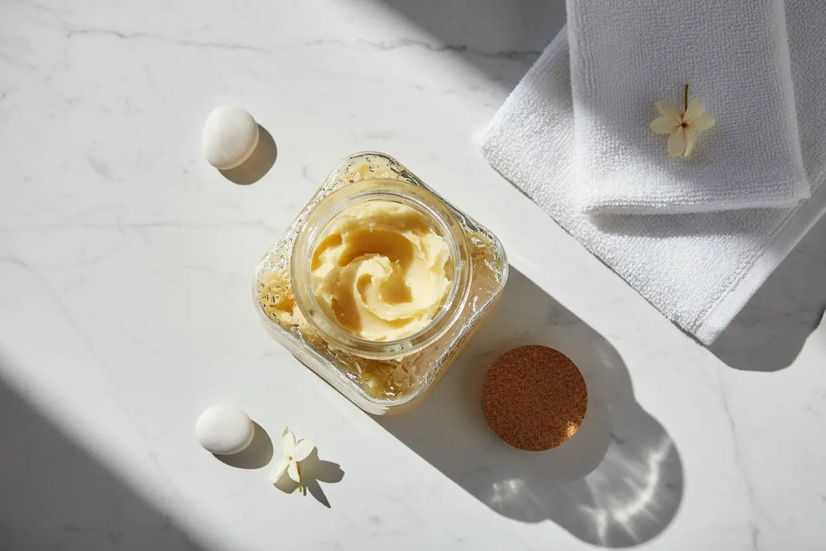 Pure unrefined plant fats displayed as the ultimate hydration sealant for applying shea butter on skin